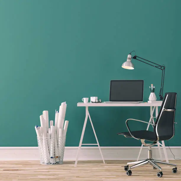 Workdesk with decoration on hardwood floor in front of empty petrol blue wall with copy space. 3D rendered image.