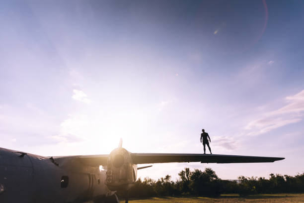istock Stuntman standing on a abandoned airplane outdoors 1058523102