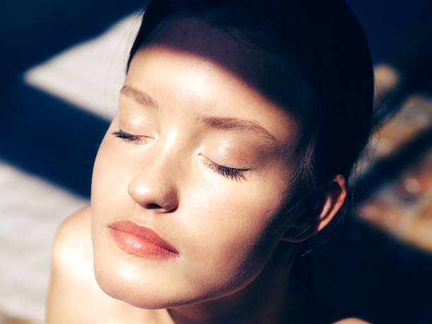 istock Closed eyes woman face natural near window. 1058524094