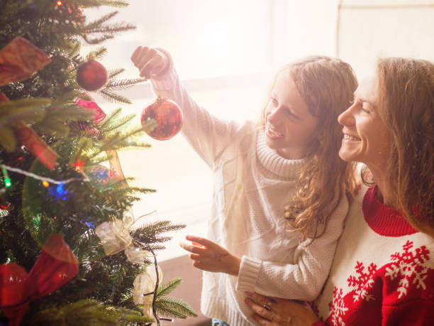 istock Mom and daughter decorate the Christmas tree 1058525614
