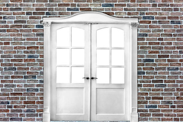 istock white double-leafed door of classical design in  old brick wall in grunge style 1058526236