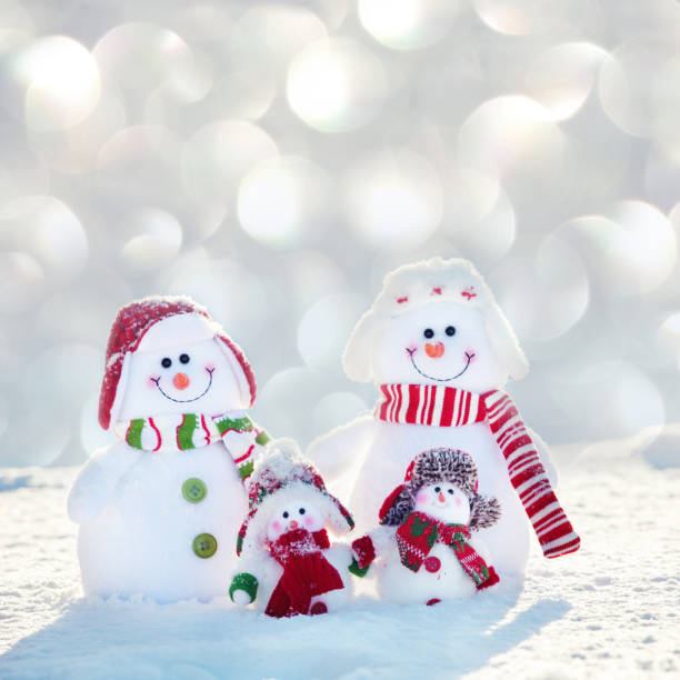 Family snowmans on snow. Friends at winter