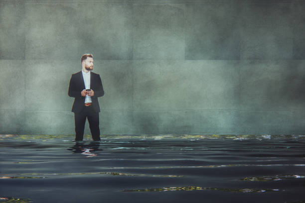 istock Young businessman standing in filthy river 1058528786