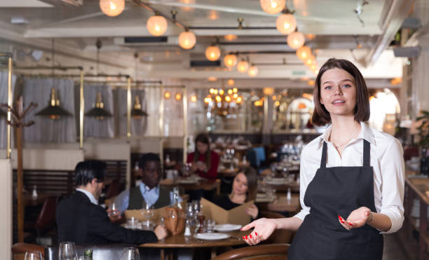 istock Waitress meeting customers in restaurant 1058529634