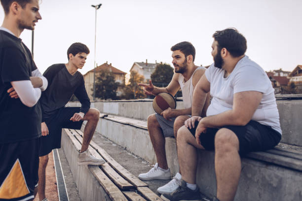 istock Basketball friends sitting on stands 1058535620