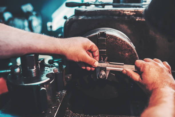 istock Operator working on the lathe machine and measuring the shaped material, close up photo. Concept of industry 1058536116