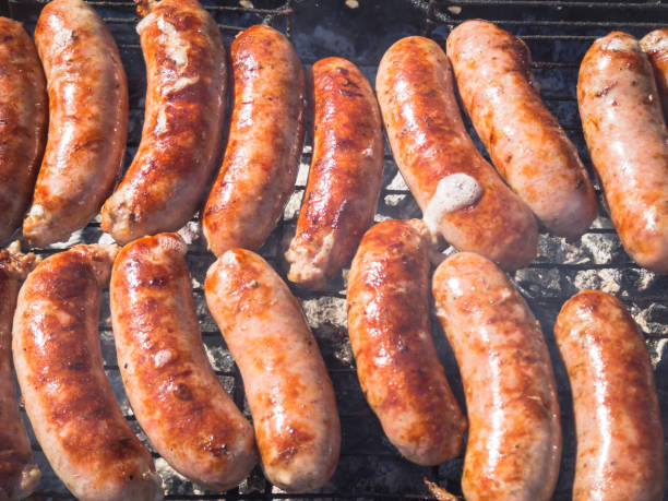 istock Meat sausages are fried on smoke. Top view. 1058538284