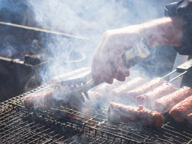 istock Romanian mititei and cooked on the grill in the smoke. 1058538384