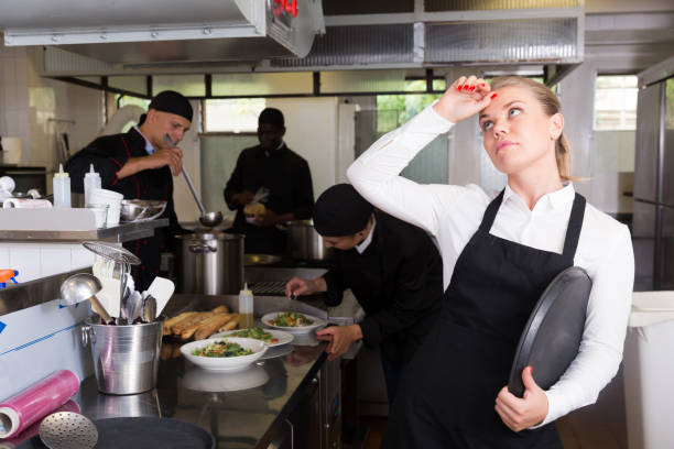 istock Unhappy waitress waiting dishes in kitchen 1058540306