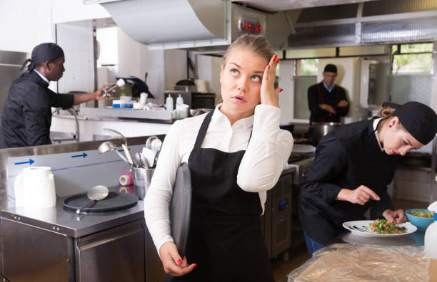 istock Unhappy waitress waiting dishes in kitchen 1058540312
