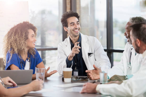 istock Group of doctors during conference table discussion 1058542240