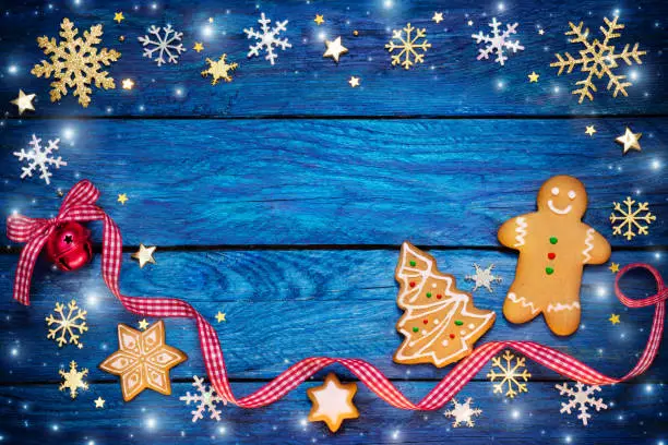 Gingerbread Cookies On Blue Wooden Table with snowfall
