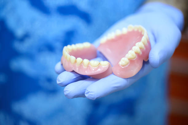 Dentist Holding Denture stock photo