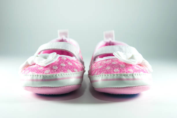 istock Pink and white children shoes on white background. 1058551736