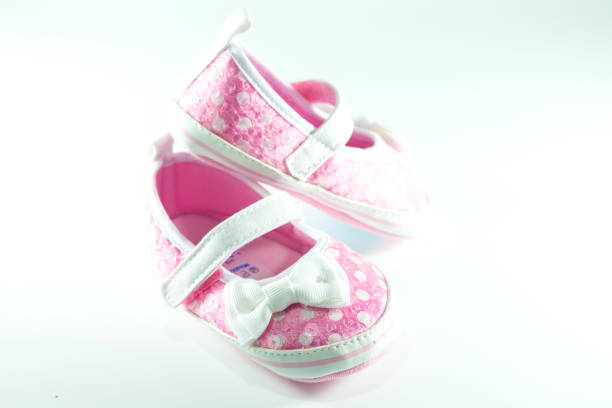 istock Pink and white children shoes on white background. 1058551810