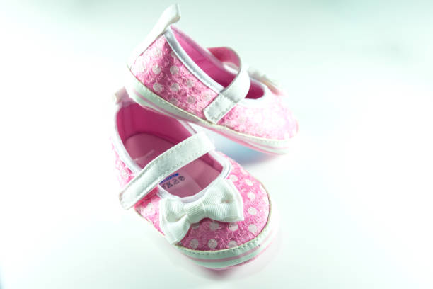 istock Pink and white children shoes on white background. 1058551814