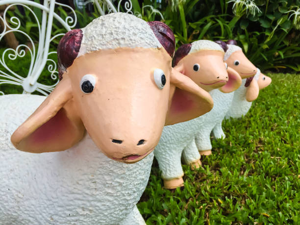 sheep statue on the grass in a garden