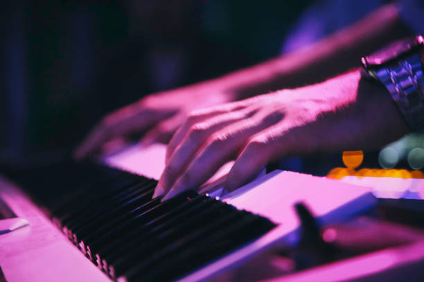 istock keyboard music - Playing a piano 1058552450