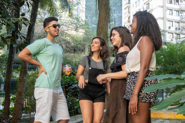istock Three girls looking to the young man 1058558094