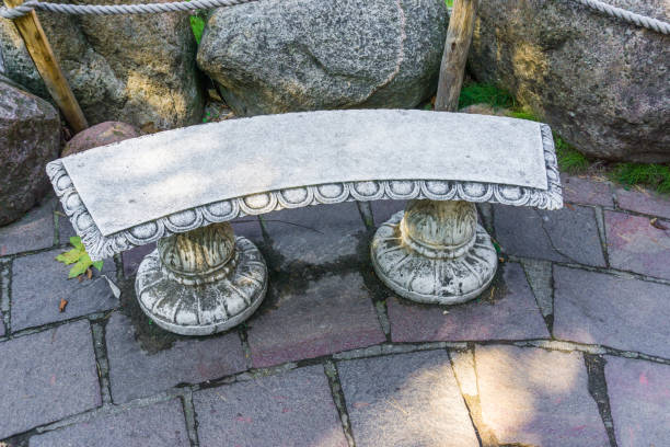 istock beautiful empty stone greek stylish bench in the garden 1058568854