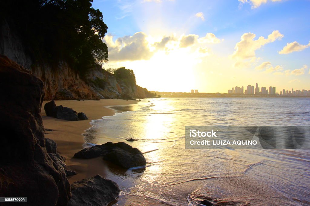 View of João Pessoa city from Ponta do Seixas beach Cliffs, rocks, plants, beach, skyline of the city, blue sky with clouds, sunshine reflected by the flat sea João Pessoa Stock Photo
