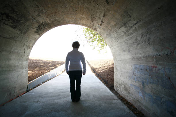 istock Woman in cement tunnel. 1058581416