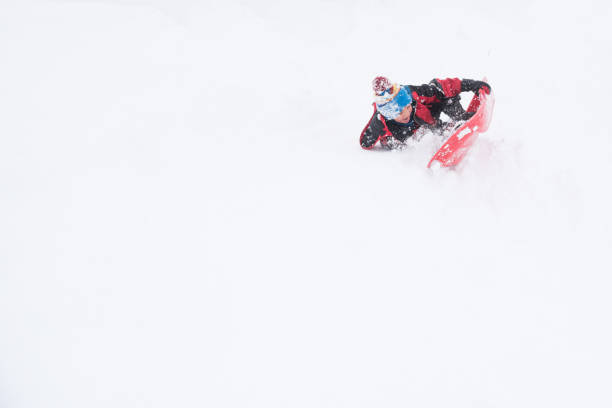 istock Child takes a big crash while sledding 1058581534