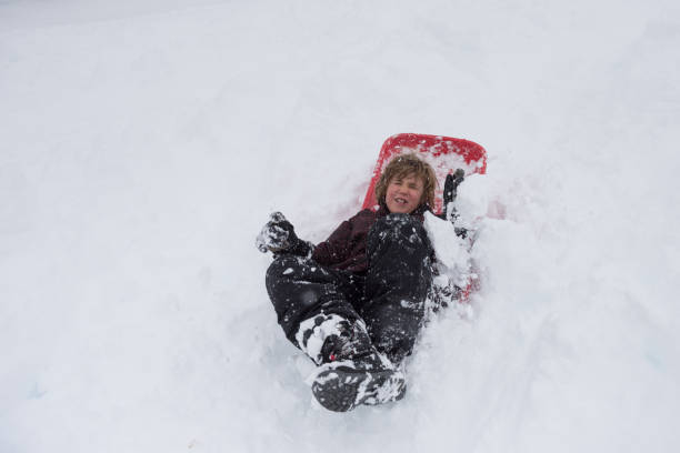 istock Child loving and laughing sledding 1058581538