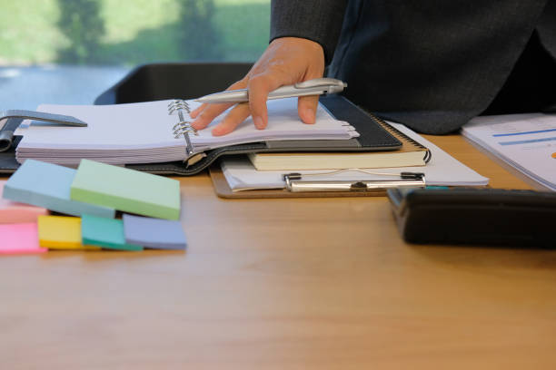 istock man organizing plan with notebook. businessman working at workplace 1058583764