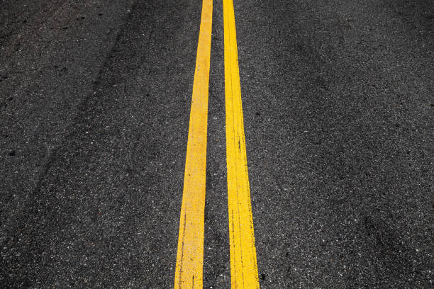 istock Yellow double dividing lines, highway road 1058586276
