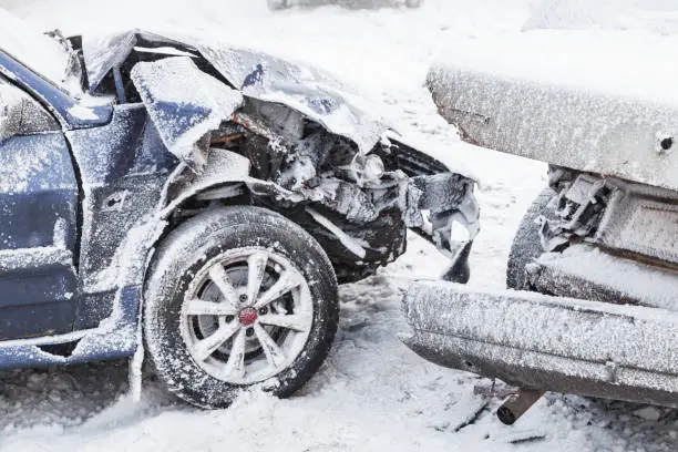 Crashed cars right after an accident on winter road with snow