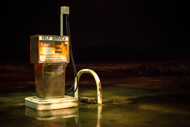 Old Fuel Pump An obsolete fuel pump sits abandoned under an overhang. vintage gas pumps stock pictures, royalty-free photos & images