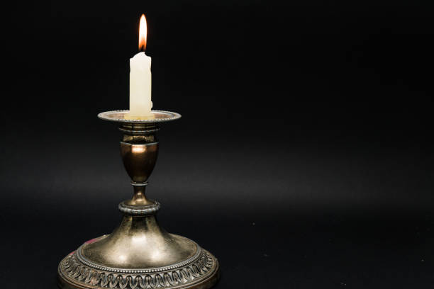 istock religious candle door isolated on a black background 1058592384