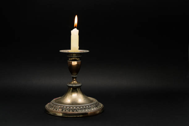 istock Candle holder isolated in black background 1058592396