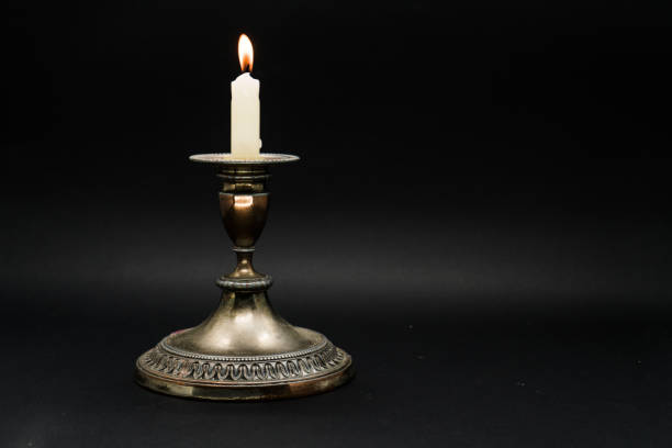 istock Old candle holder isolated in black background 1058592410