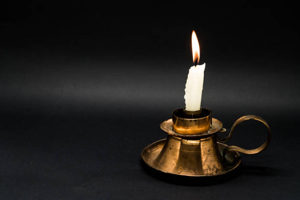 istock Old candle holder with lighted candle 1058593432