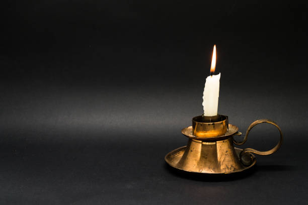 istock Vintage candle holder isolated in black background 1058593438