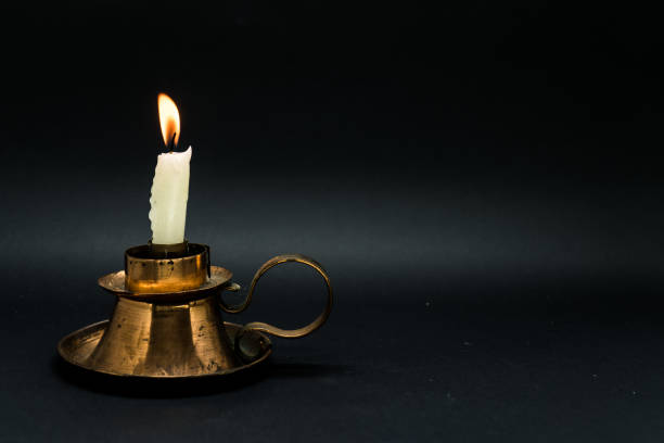 istock Vintage candle holder isolated in black background 1058593442