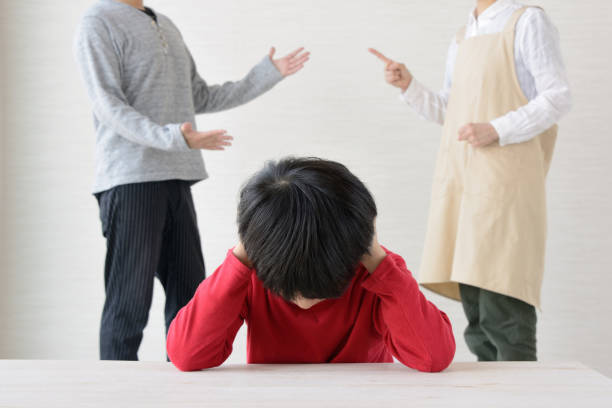 istock Child depressed by quarrel between father and mother 1058596882