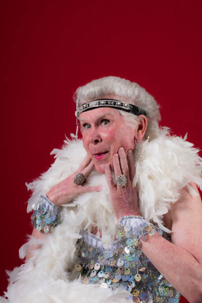 istock Older man cross dressed with boa,headband and sequins. 1058604614