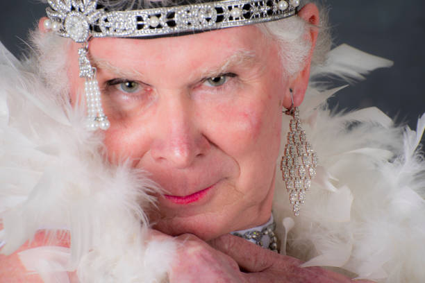 istock Older man cross dressed with ,boa and headband. 1058604764