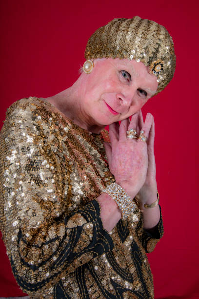 istock Cross dressed 70 year old man in gold lame dancing. 1058606038