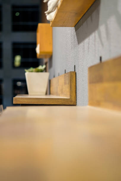 The chairs sit on the wall and have shelves.