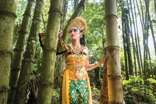 istock Young traditional Bali dancer in a bamboo forest 1058612002