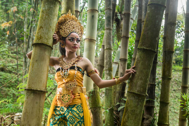 istock Young traditional Bali dancer in a bamboo forest 1058612136