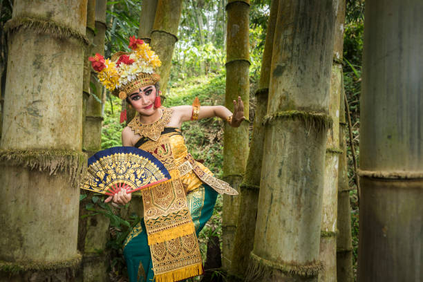 istock Young traditional Bali dancer in a bamboo forest 1058616260