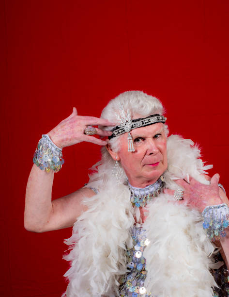 istock Older man cross dressed with boa,headband and sequins. 1058622900