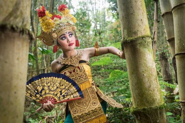 istock Young traditional Bali dancer in a bamboo forest 1058626448