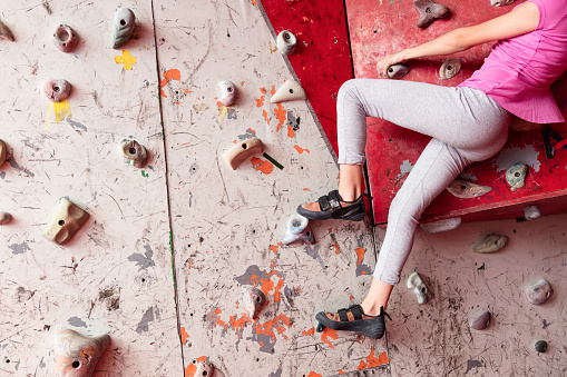 Close up of unrecognizable female teenager climbing a wall - Extreme Sports