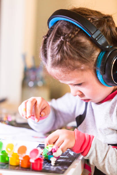 istock Little girl working on her art project 1058627346